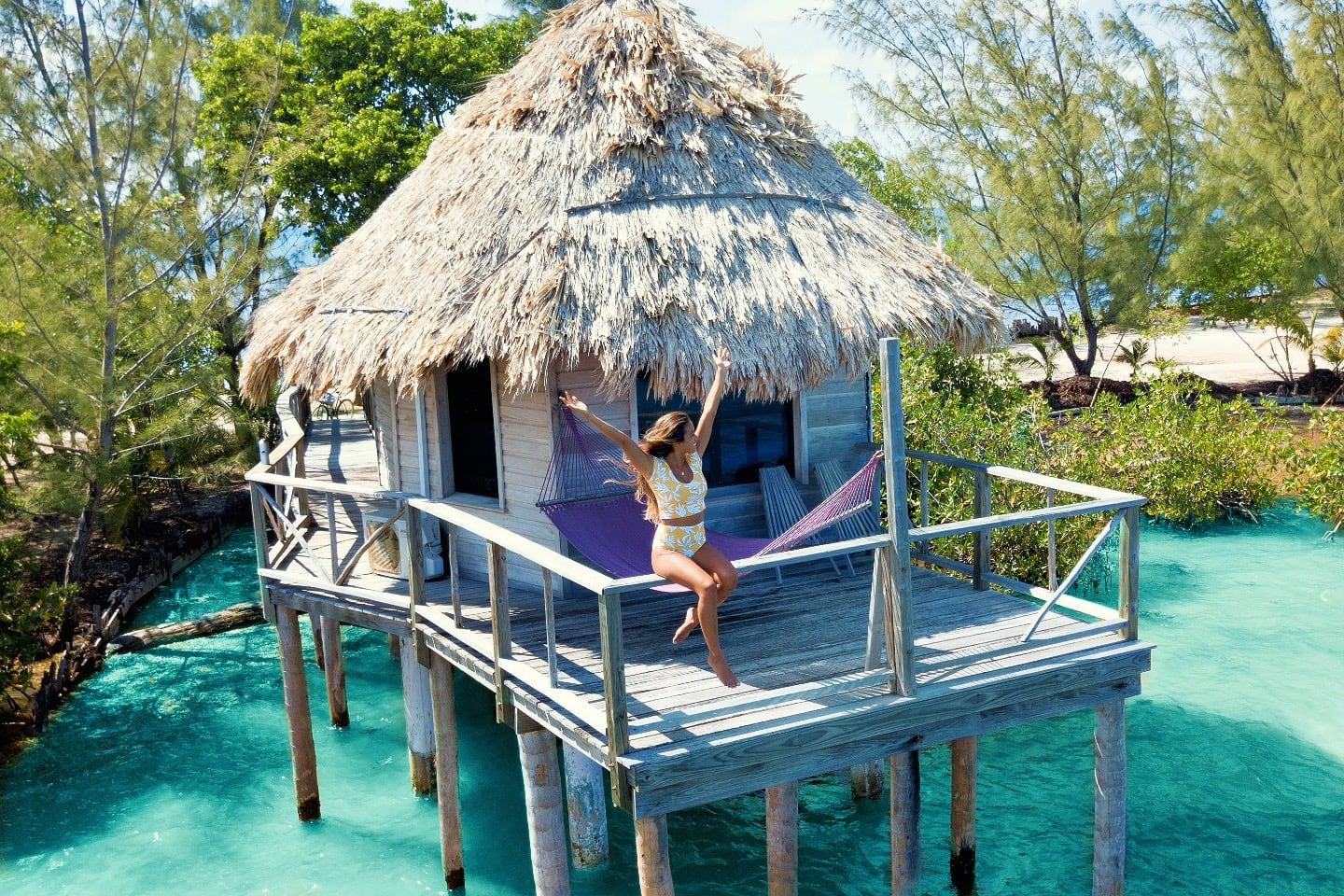woman sitting on overwater bungalow in the Caribbean
