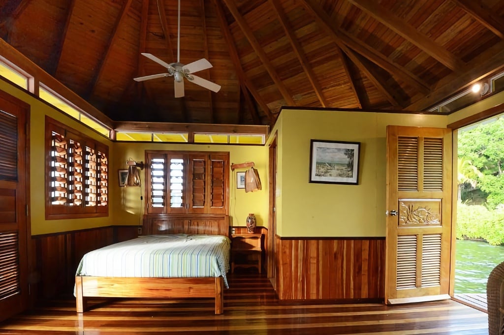 interior of water bungalow with wooden roof and floors
