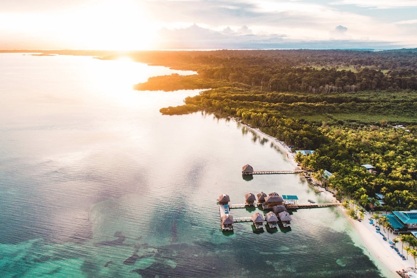 sunset and water overwater bungalows in the Caribbean