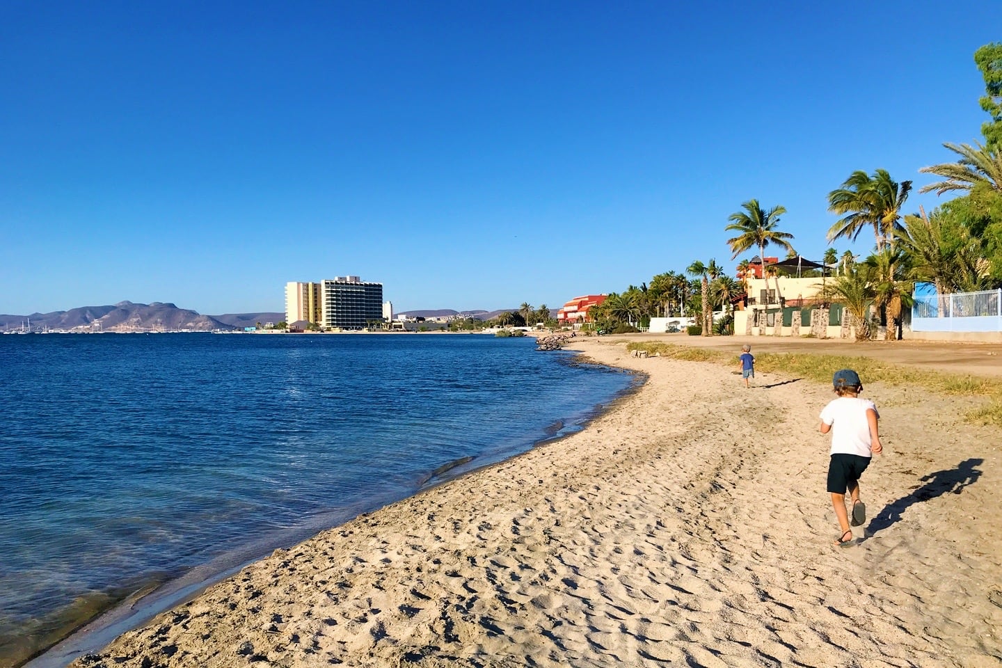 children playing on Playa El Conchalito in La Posada (Benito Juarez) neighborhood La Paz BCS