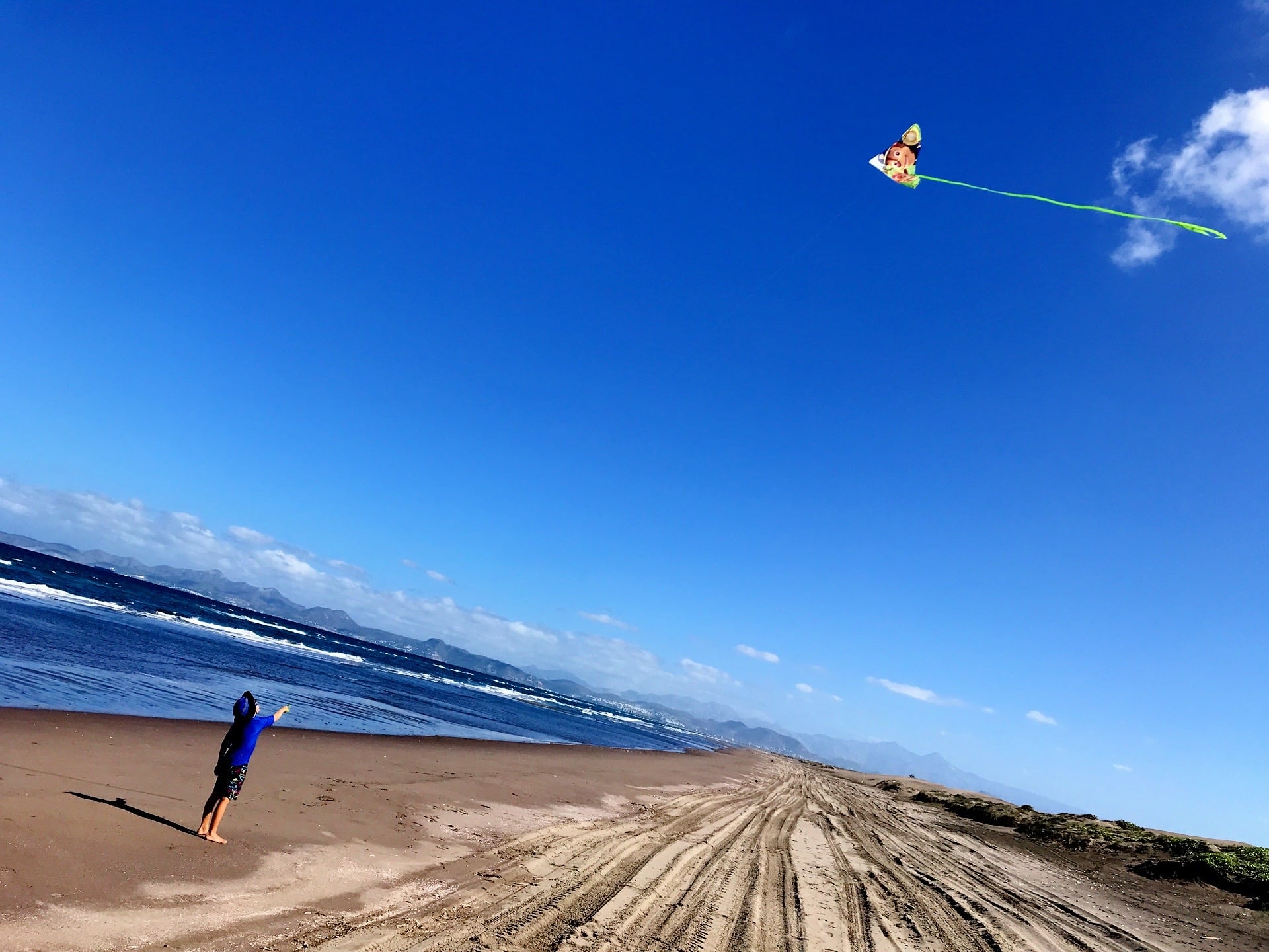 child flying kite on Playa El Mogote La Paz beaches