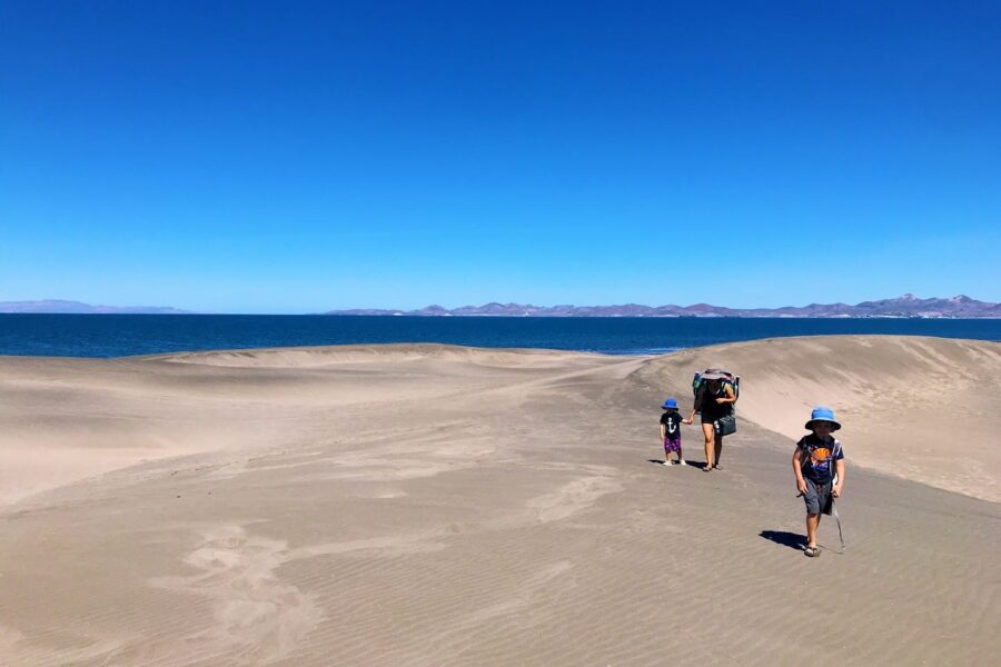 family walking on dunes at El Mogote, La Paz, BCS