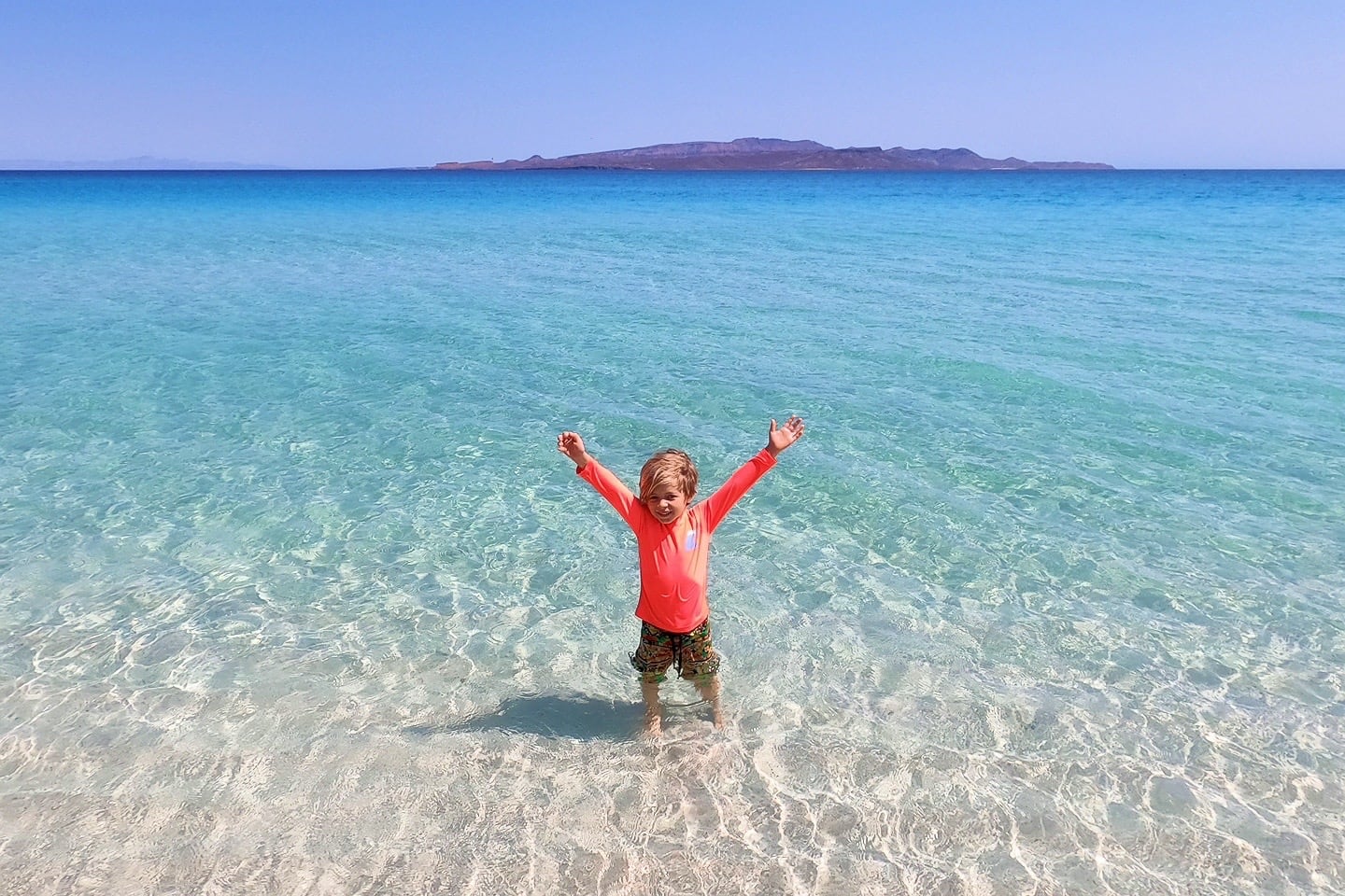 child in clear ocean