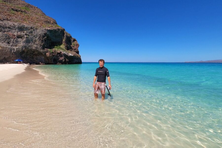 man with snorkel gear on beach