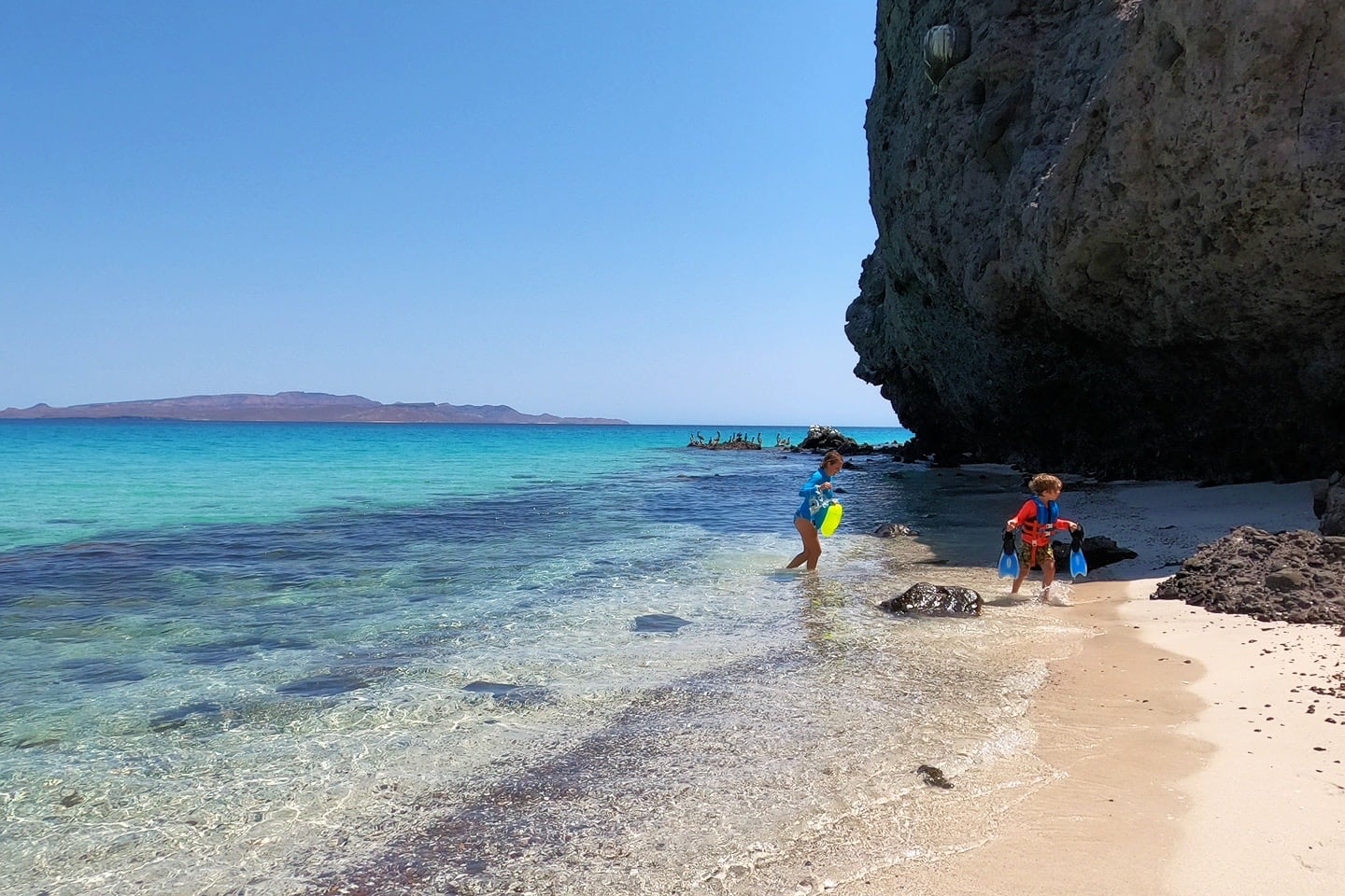 snorkelers at hidden cove between Playa Tecolote and Playa Tecolote