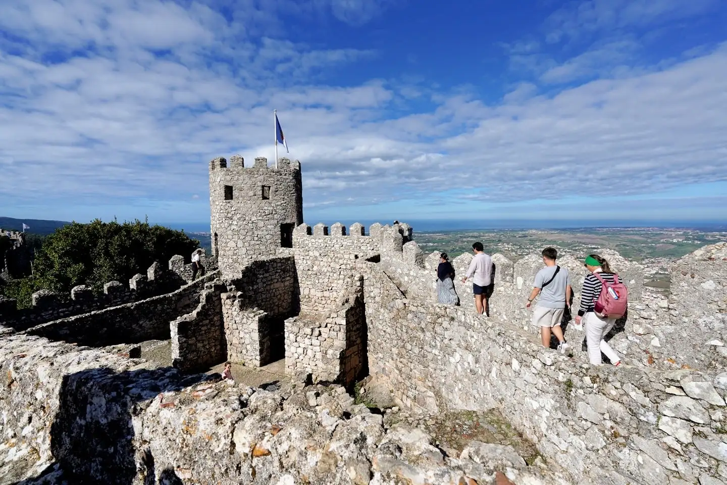 visitors walking the ramparts of the Moorish Castle in Sintra Portugal