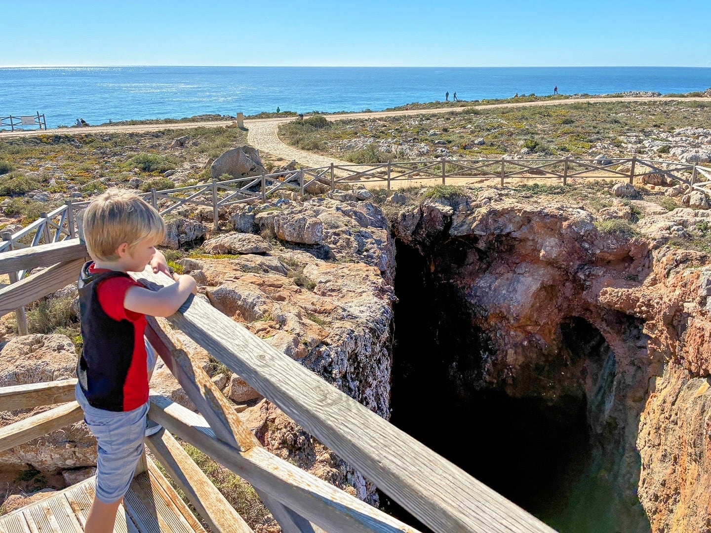 child peering into cave